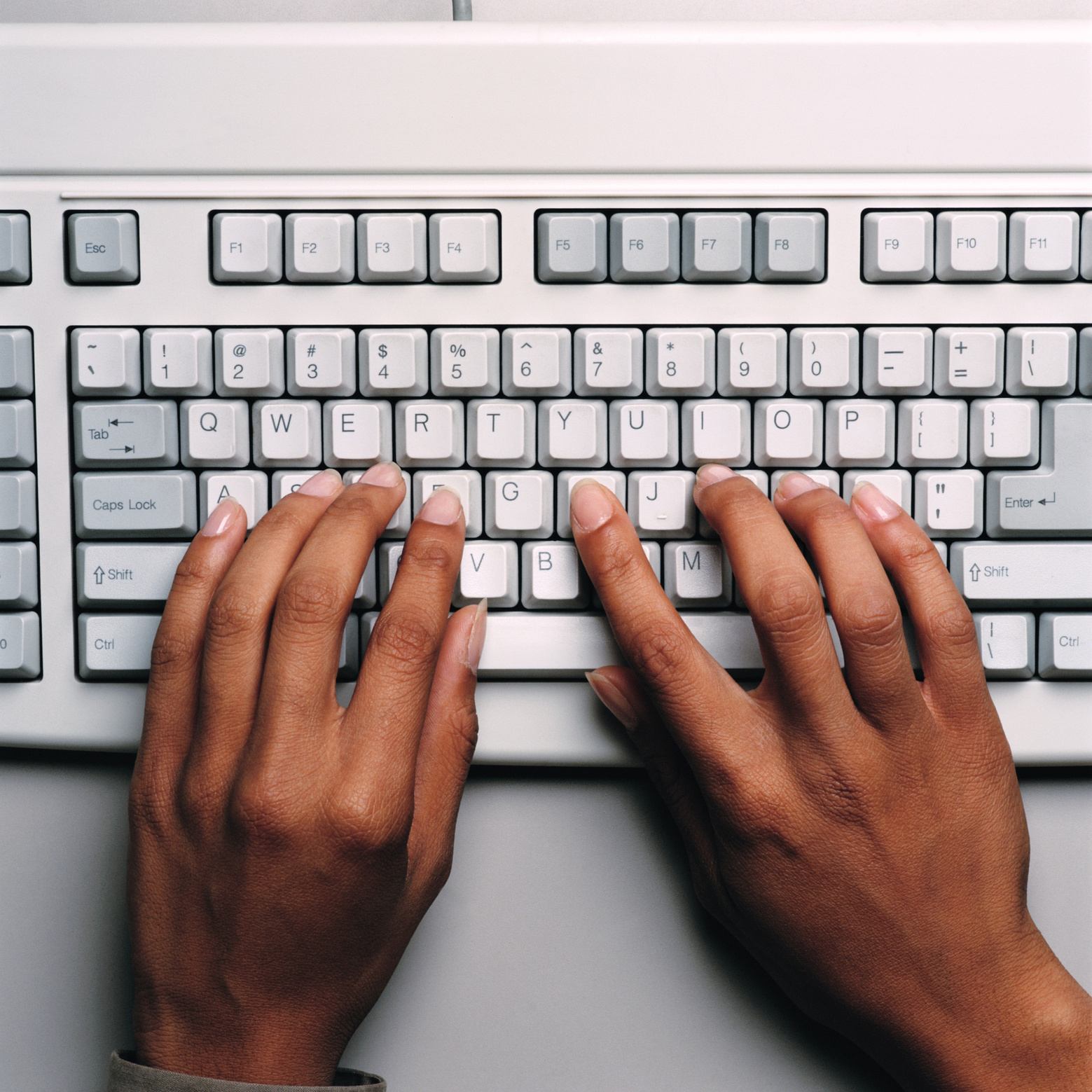 Hands Typing on Computer Keyboard