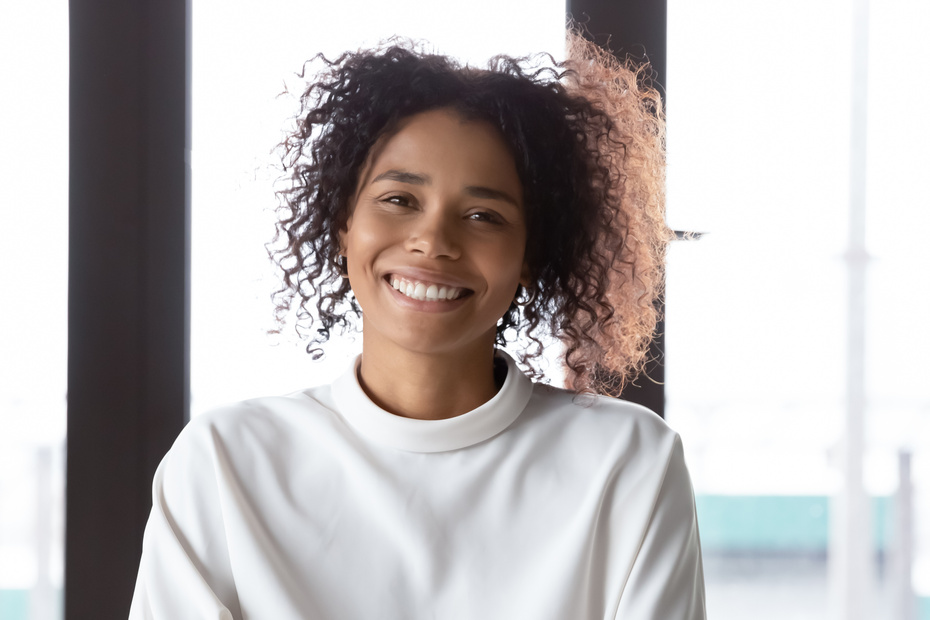 Profile picture of smiling biracial female employee